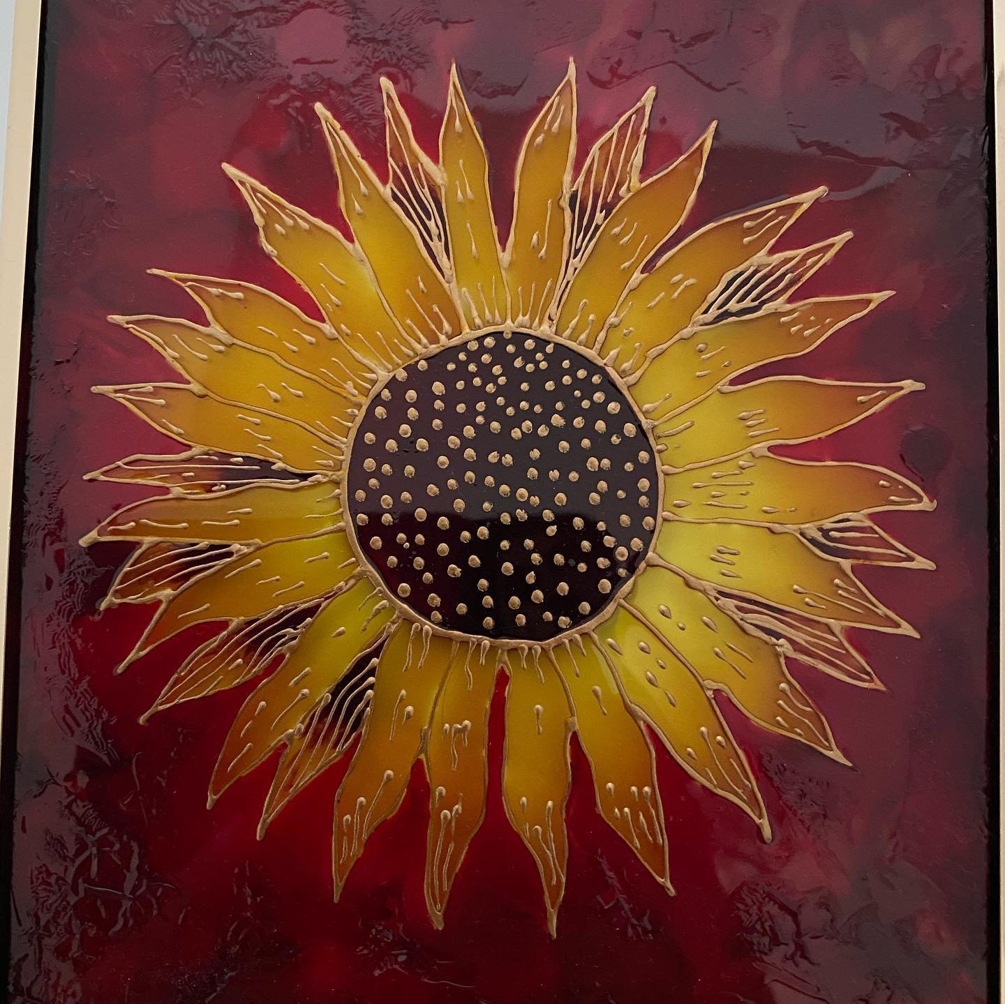 Sunflower painted on crimson glass background